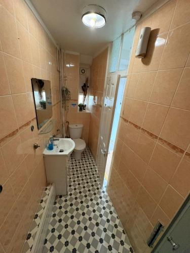 a bathroom with a sink and a toilet and a shower at Stylish Room in Central London! in London