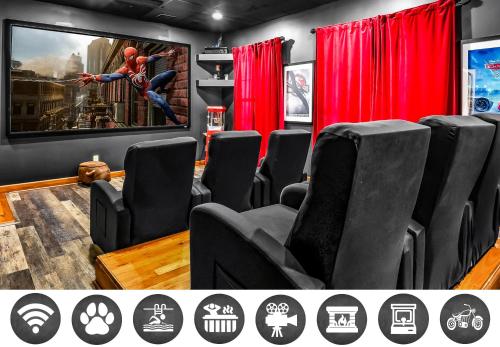 a movie room with black chairs and a tv at Hey Diddle Diddle cabin in Pigeon Forge