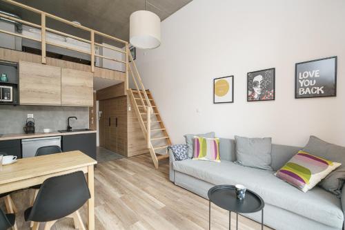 a living room with a couch and a loft bed at Sleep & Fly & Stay Comfort Apartament I in Wrocław