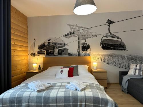 a bedroom with a bed with two towels on it at Villa pod Skrzycznem in Szczyrk