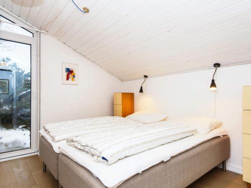 a bed in a room with a window at 12 person holiday home in Fanø-By Traum in Fanø