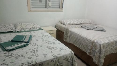 En eller flere senge i et værelse på Pousada Maria