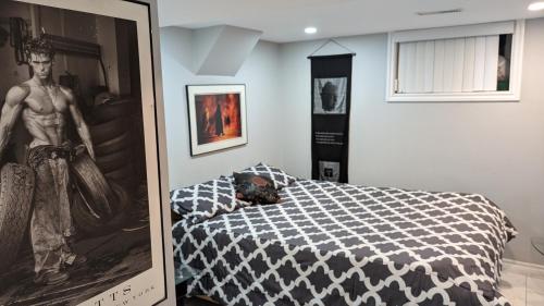 a bedroom with a bed and a picture on the wall at Chic Japanese Vibe Smart Home- Liberty Village 10 min walk to CNE & GO Station in Toronto