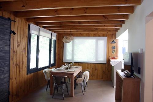 a kitchen with a table and chairs and a window at Cabaña martita in San Martín de los Andes