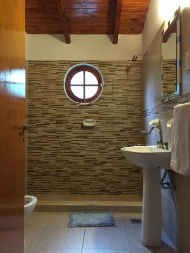 a bathroom with a sink and a window at Tierras de Breena in Los Reartes