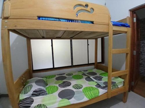 a bunk bed with a wooden bunk bed frame at Hotel Perezoso in Iquitos