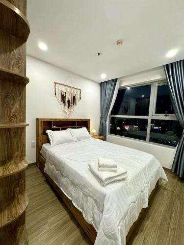 Giường trong phòng chung tại Happy One Central Bình Dương