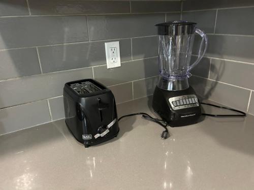 a blender and a toaster sitting on a counter at Family friendly home at Chappelle garden in Edmonton