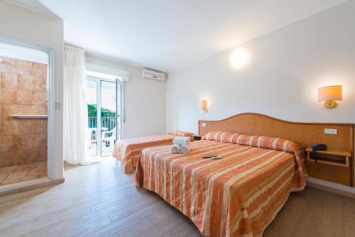 Postel nebo postele na pokoji v ubytování Hotel Falco