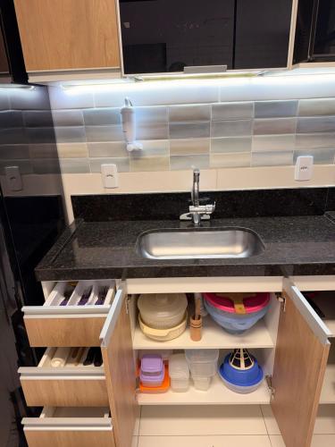 a kitchen with a sink and a counter at Refúgio de luxo in Pedra de Guaratiba