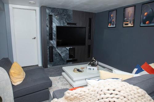 a living room with a couch and a tv at One-bedroom guest suite with private entry in Winnipeg