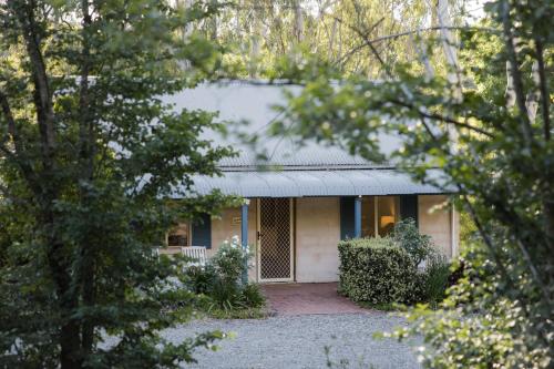 a house is seen through the trees at Donnybrook Cottages - Hutt River in Clare