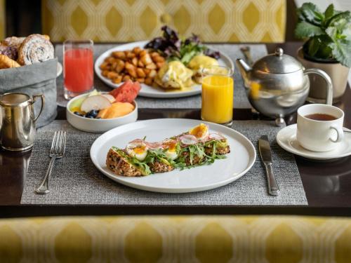 a breakfast table with plates of food and drinks at Fairmont Chateau Laurier in Ottawa