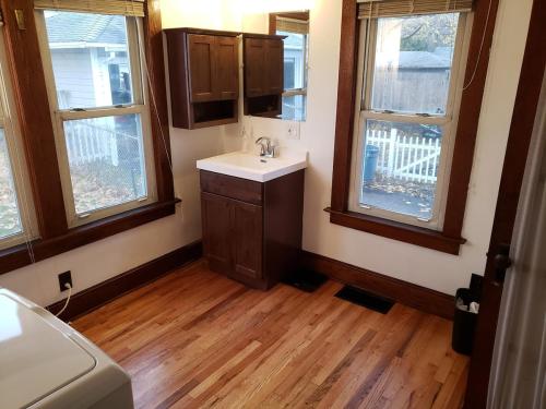 a bathroom with a sink and two windows at Grand Central - Pet friendly 3 BR 2 Bath in Johnson City