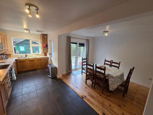 a kitchen and dining room with a table and chairs at Eagle Valley , Wilton 4BR Extended Stays near CUH & UCC in Cork