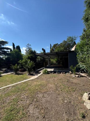 a house with a large yard with a building at Chalet La Isolina in Villa Giardino
