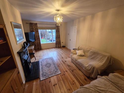 a living room with a bed and a couch at Eagle Valley , Wilton 4BR Extended Stays near CUH & UCC in Cork
