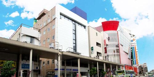 a group of buildings on a city street with at Rembrandt inn Aomori in Aomori