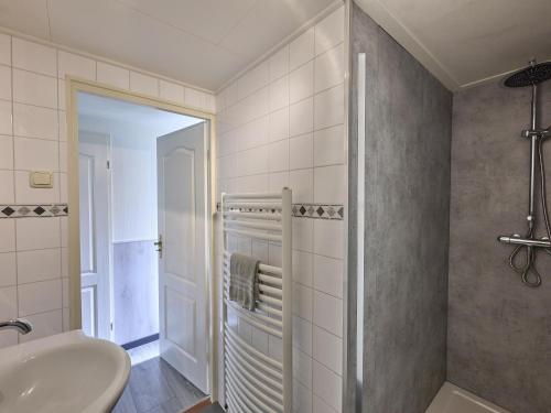 a bathroom with a sink and a tub and a shower at t Kaatsheuveltje 7 in Kaatsheuvel