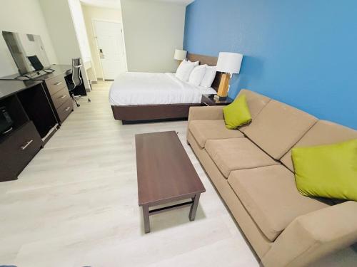 a living room with a couch and a bed at Hallmark Inn & Suites Newly Renovated Rooms San Antonio Northeast in San Antonio