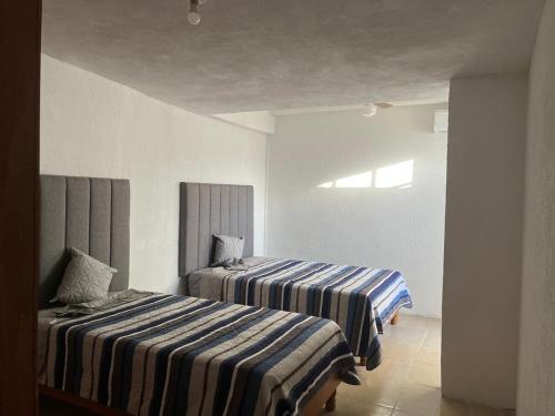 Ένα ή περισσότερα κρεβάτια σε δωμάτιο στο Cozy and family-friendly house CARE and UANL