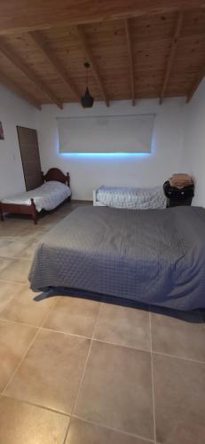 a bedroom with a bed and a chair in it at Las Blanco in Sierra Grande