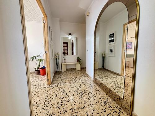 a hallway with a large mirror and a room at Vistamar Porto Cristo in Porto Cristo