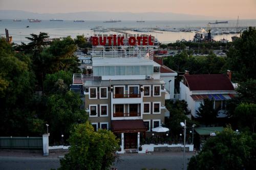 a building with a red sign on top of it at Butik Pendik Hotel in Istanbul