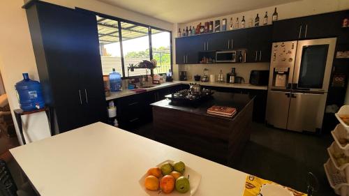 a kitchen with a table with a bowl of fruit on it at Habitación master # 1 in Macas
