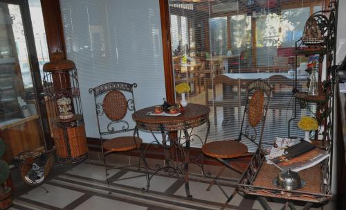 a room with chairs and a table and a bird cage at Butik Pendik Hotel in Istanbul