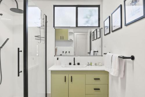 a bathroom with a sink and a mirror at Glenkeen Farm and Cabins in Bellbrae