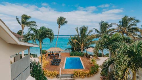 an aerial view of a resort with a swimming pool and the ocean at Moana Sands Beachfront Villas in Rarotonga