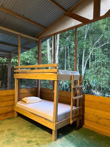 a bedroom with bunk beds on a porch at K'erenda Homet Reserva Natural in Puerto Maldonado