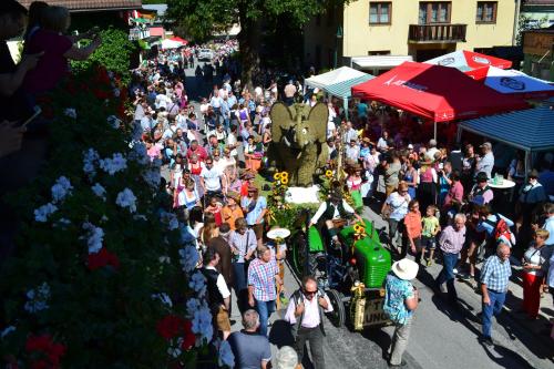 a crowd of people walking down a street in a parade at Pension Haus Rohrmoser in Annaberg im Lammertal