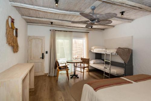 a bedroom with a ceiling fan and a bunk bed at Casa Solcor Boutique Bed & Breakfast in San Pedro de Atacama