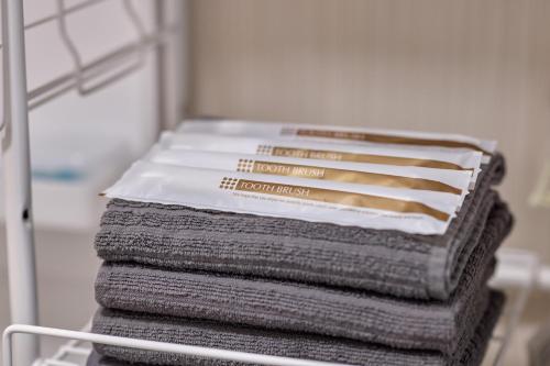 a stack of towels sitting on a rack in a refrigerator at APROStay富士河口湖小立17 in Fujikawaguchiko