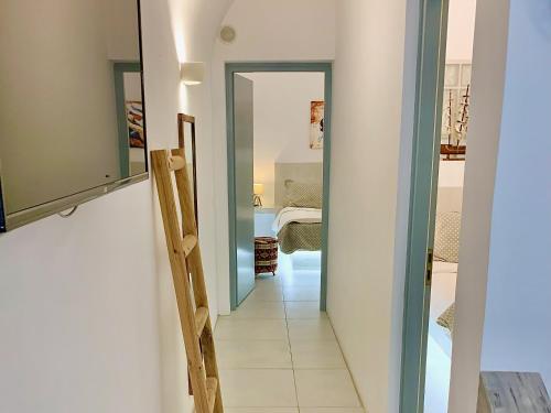 a hallway with a door leading to a bedroom at Lupi's Cave House in Fira