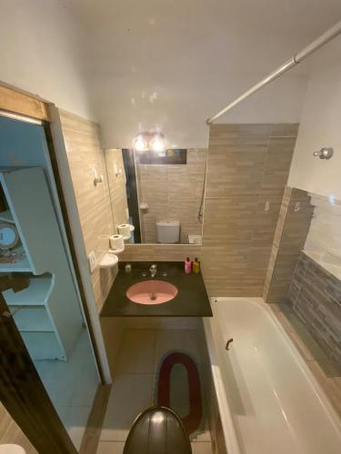 a bathroom with a sink and a toilet and a tub at Garden! in Villa Ballester