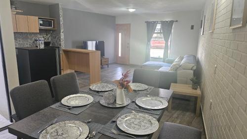 a dining table with plates on it in a living room at Suite Perote in Perote