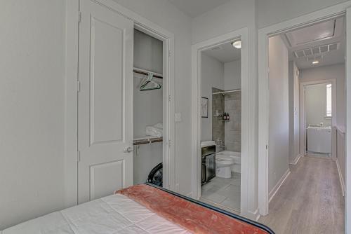 a white room with a bed and a bathroom at Elegant 3 BED Home Walk To Riverwalk/Pearl/St Mary in San Antonio