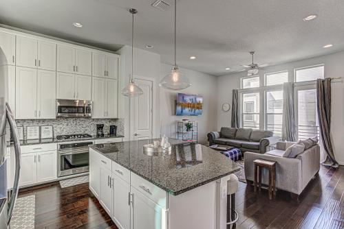 a kitchen with white cabinets and a living room at Elegant 3 BED Home Walk To Riverwalk/Pearl/St Mary in San Antonio