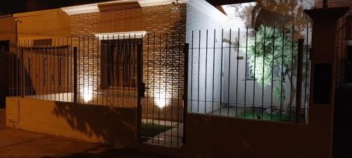 a building with a gate on the side of it at El retamo - Casa Turística in San Rafael