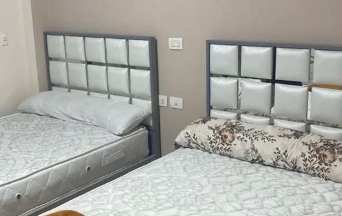 a bedroom with two twin beds next to each other at Metallistix wine in Irvine