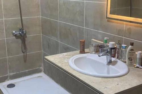 a bathroom with a sink and a shower at Metallistix wine in Irvine