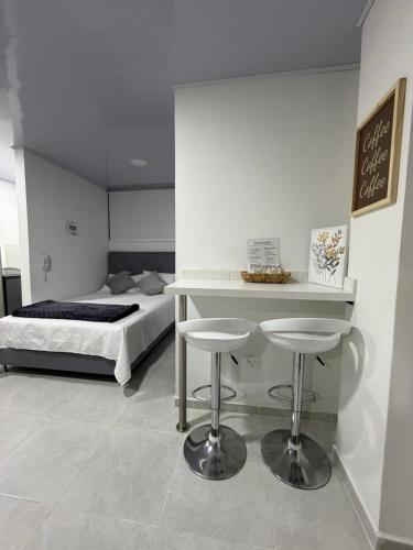 En eller flere senge i et værelse på Loft en el corazón de Santa Rosa de Cabal