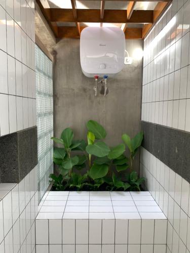 a bathroom with a shower with plants in it at Alena Villa Private Pool in Blimbing