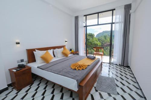 a bedroom with a large bed with a large window at Ivory Canopy Resort - Ella in Ella
