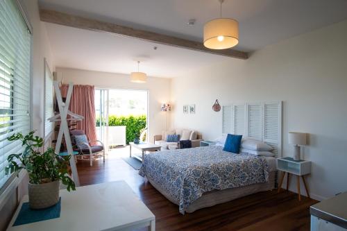 a bedroom with a bed and a living room at Leigh Central in Leigh