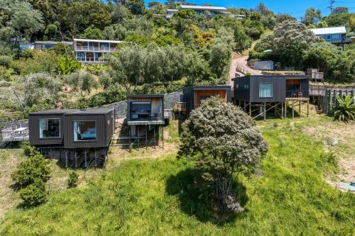 an aerial view of a group of tiny homes on a hill at Hidden Valley Waiheke in Palm Beach