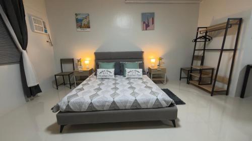 a bedroom with a bed with two pillows on it at Camella Verdant - Dolcevita Residence in Puerto Princesa City